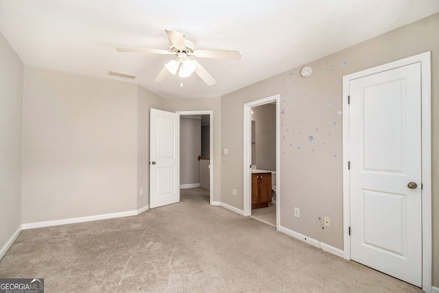 2551 Village Creek Lndg SE, Atlanta, GA 30316 - unfurnished bedroom with light colored carpet, baseboards, connected bathroom, and a ceiling fan