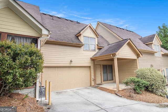 2551 Village Creek Lndg SE, Atlanta, GA 30316 - view of front of home featuring concrete driveway, a garage, and a shingled roof