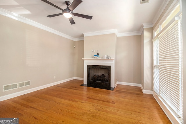 2551 Village Creek Lndg SE, Atlanta, GA 30316 - unfurnished living room featuring a high end fireplace, crown molding, light wood-style floors, baseboards, and a ceiling fan