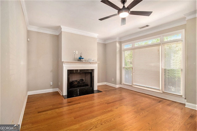 2551 Village Creek Lndg SE, Atlanta, GA 30316 - unfurnished living room with a fireplace, crown molding, baseboards, wood finished floors, and a ceiling fan