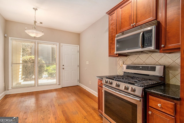 2551 Village Creek Lndg SE, Atlanta, GA 30316 - kitchen featuring stainless steel appliances, baseboards, backsplash, and pendant lighting