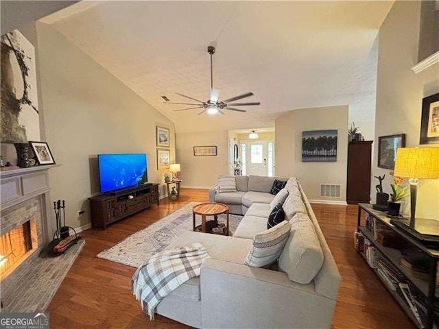 4025 Mcdowell Dr, Acworth, GA 30101 - living area with a ceiling fan, a fireplace with raised hearth, lofted ceiling, wood finished floors, and baseboards
