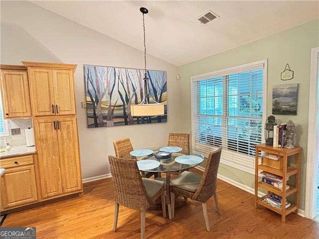 4025 Mcdowell Dr, Acworth, GA 30101 - dining area featuring vaulted ceiling, light wood-type flooring, and baseboards