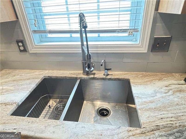 4025 Mcdowell Dr, Acworth, GA 30101 - kitchen view of a sink, decorative backsplash, and light stone countertops