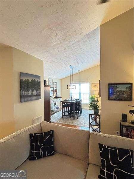 4025 Mcdowell Dr, Acworth, GA 30101 - living area featuring a textured ceiling and lofted ceiling