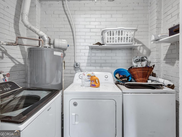 3059 Will Rogers Pl SE, Atlanta, GA 30316 - laundry room featuring independent washer and dryer, water heater, and brick wall