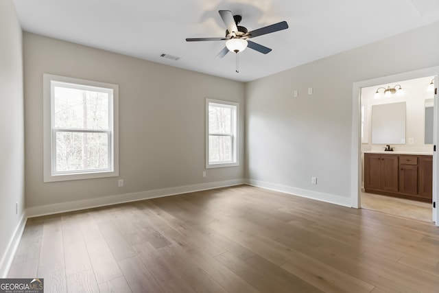 113 Summit View Ln, Ellijay, GA 30540 - unfurnished bedroom with a sink, light wood-style floors, baseboards, and connected bathroom