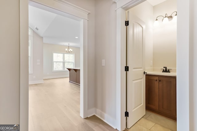 113 Summit View Ln, Ellijay, GA 30540 - hall with a sink, a chandelier, and baseboards