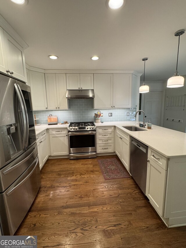 3146 Weymouth Dr, Marietta, GA 30062 - kitchen with stainless steel appliances, under cabinet range hood, a sink, a peninsula, and light countertops