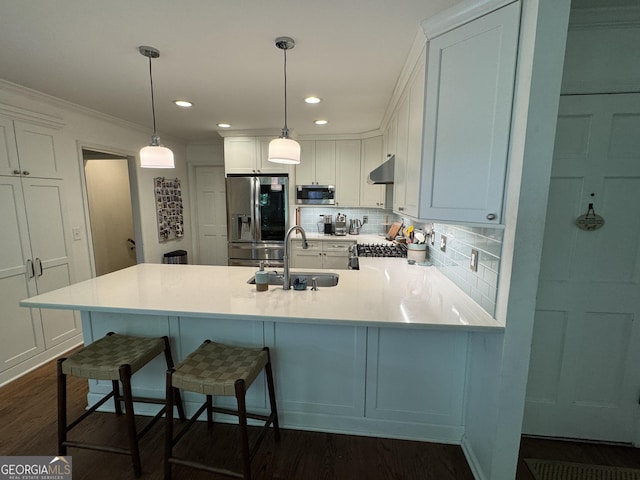 3146 Weymouth Dr, Marietta, GA 30062 - kitchen featuring appliances with stainless steel finishes, ventilation hood, a sink, a peninsula, and decorative backsplash