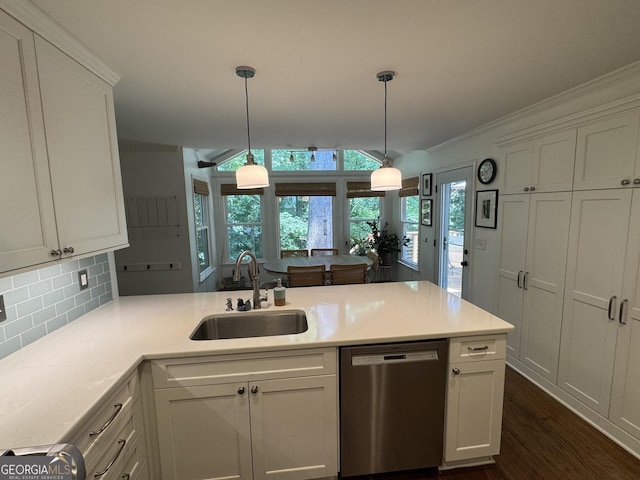 3146 Weymouth Dr, Marietta, GA 30062 - kitchen featuring stainless steel dishwasher, a sink, backsplash, ornamental molding, and light countertops