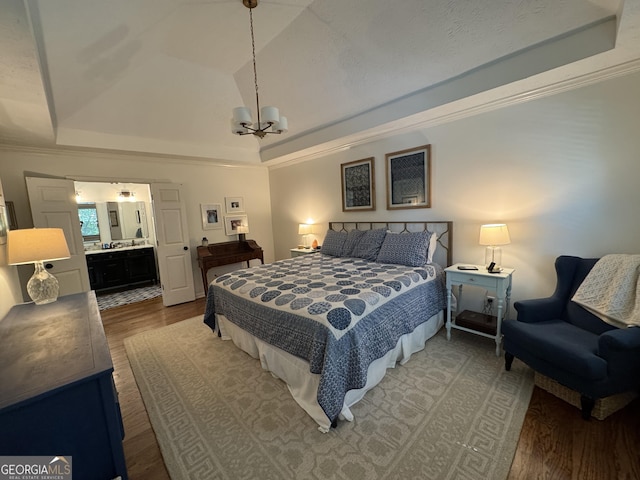 3146 Weymouth Dr, Marietta, GA 30062 - bedroom with a raised ceiling, wood finished floors, a chandelier, connected bathroom, and crown molding