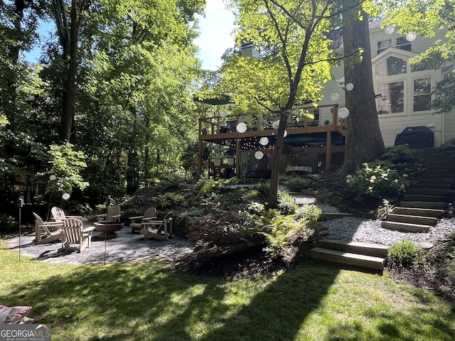 3146 Weymouth Dr, Marietta, GA 30062 - view of grassy yard with stairway, an outdoor fire pit, a patio, and a deck
