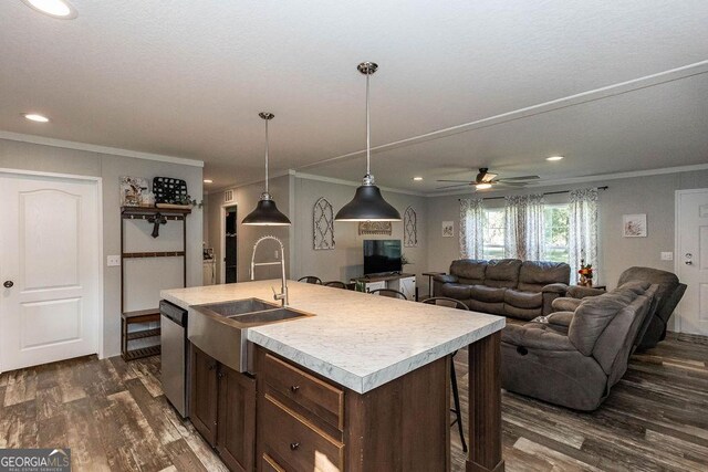 1208 Nease Rd, Guyton, GA 31312 - kitchen featuring dark wood finished floors, a sink, light countertops, stainless steel dishwasher, and crown molding