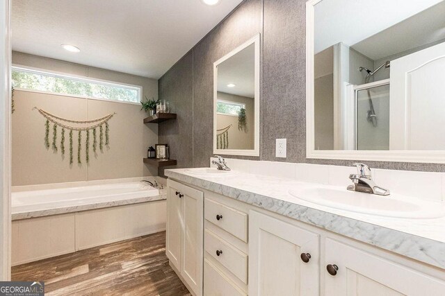 1208 Nease Rd, Guyton, GA 31312 - full bathroom with a stall shower, wood finished floors, a garden tub, and double vanity