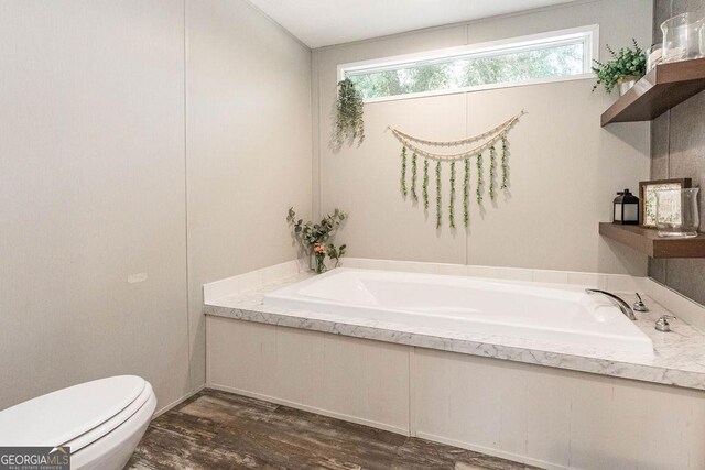 1208 Nease Rd, Guyton, GA 31312 - full bath featuring toilet, a garden tub, and wood finished floors