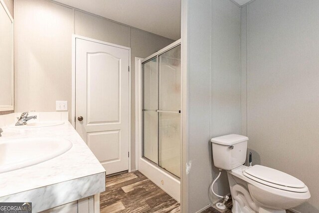 1208 Nease Rd, Guyton, GA 31312 - bathroom featuring toilet, a shower with door, wood finished floors, and double vanity