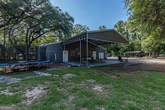 1208 Nease Rd, Guyton, GA 31312 - exterior space featuring a trampoline, a patio area, and a yard