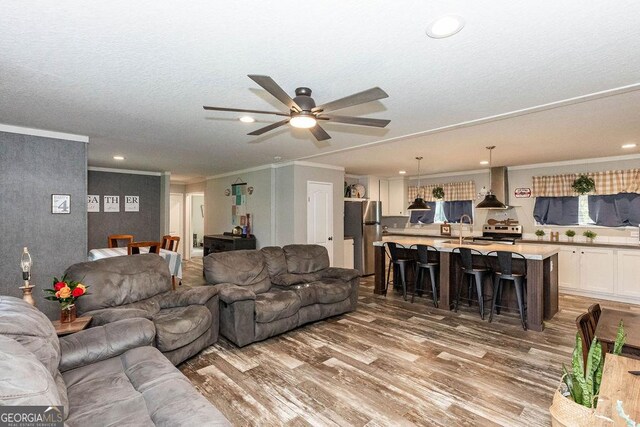1208 Nease Rd, Guyton, GA 31312 - living area with wood finished floors, crown molding, a ceiling fan, and recessed lighting