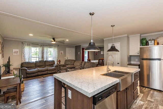 1208 Nease Rd, Guyton, GA 31312 - kitchen with stainless steel appliances, a sink, wood finished floors, light countertops, and pendant lighting
