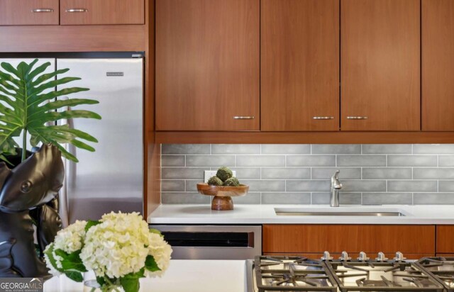1058 Piedmont Ave Unit 103, Atlanta, GA 30309 - kitchen featuring a sink, appliances with stainless steel finishes, light countertops, and backsplash
