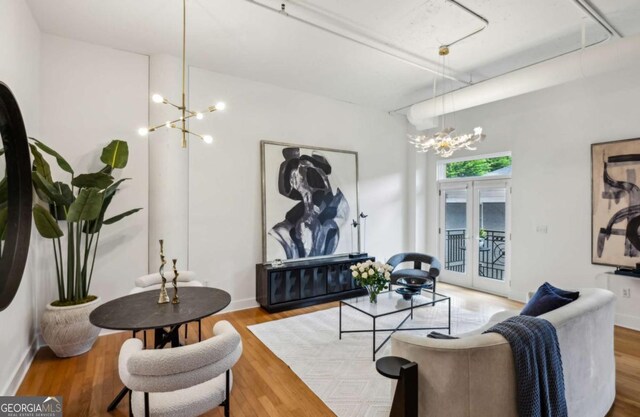 1058 Piedmont Ave Unit 103, Atlanta, GA 30309 - living area featuring a chandelier, wood finished floors, and baseboards