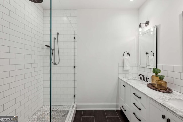 1058 Piedmont Ave Unit 103, Atlanta, GA 30309 - full bath featuring a tile shower, tile patterned floors, double vanity, backsplash, and baseboards