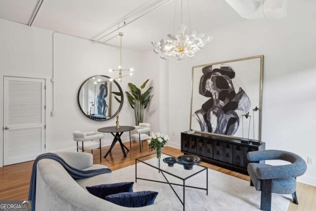 1058 Piedmont Ave Unit 103, Atlanta, GA 30309 - living area with a chandelier, wood finished floors, and baseboards
