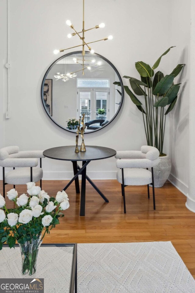 1058 Piedmont Ave Unit 103, Atlanta, GA 30309 - dining area view of baseboards, wood finished floors, a chandelier, and french doors