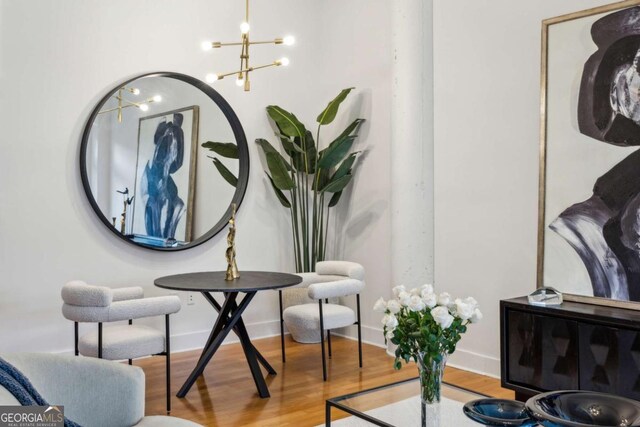 1058 Piedmont Ave Unit 103, Atlanta, GA 30309 - living area featuring a chandelier, wood finished floors, and baseboards