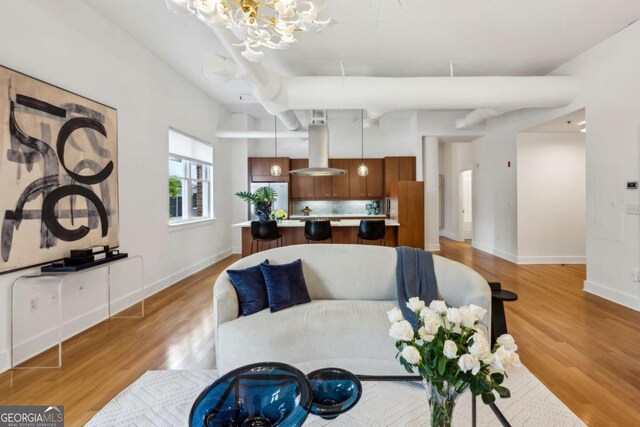 1058 Piedmont Ave Unit 103, Atlanta, GA 30309 - living area featuring a chandelier, light wood-style flooring, and baseboards