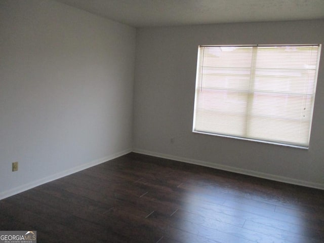 102 Westcliff Ctr Unit D, Warner Robins, GA 31093 - empty room with dark wood-style floors, baseboards, and plenty of natural light