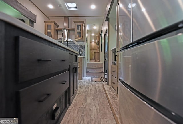 86 Moccasin Ln Unit 16, Blairsville, GA 30512 - interior space featuring freestanding refrigerator, light wood-style flooring, backsplash, and glass insert cabinets