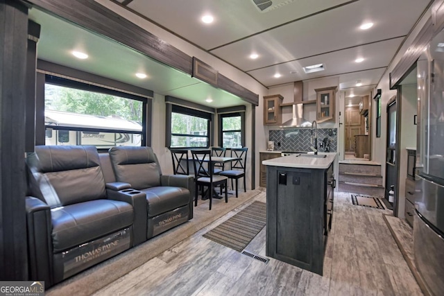 86 Moccasin Ln Unit 16, Blairsville, GA 30512 - kitchen featuring light countertops, open floor plan, decorative backsplash, a kitchen island, and glass insert cabinets