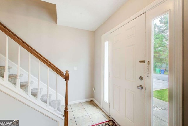 3099 Regency Park Dr, Lithonia, GA 30038 - foyer entrance featuring healthy amount of natural light, stairs, light tile patterned floors, and baseboards