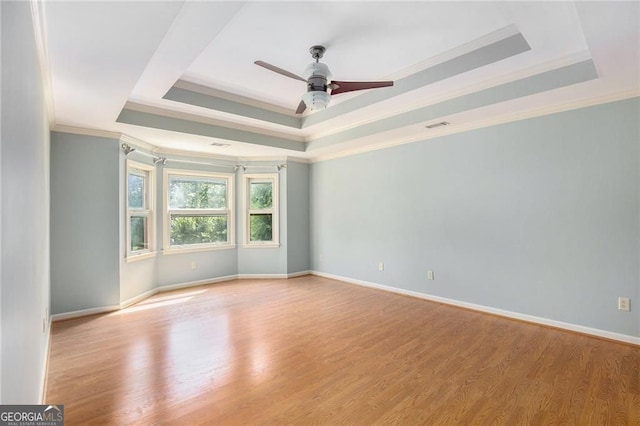 106 Waterford Pl, Acworth, GA 30101 - empty room featuring a tray ceiling, crown molding, ceiling fan, and wood finished floors