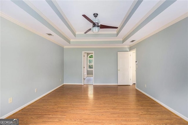 106 Waterford Pl, Acworth, GA 30101 - spare room featuring a tray ceiling, ceiling fan, crown molding, light wood-type flooring, and baseboards