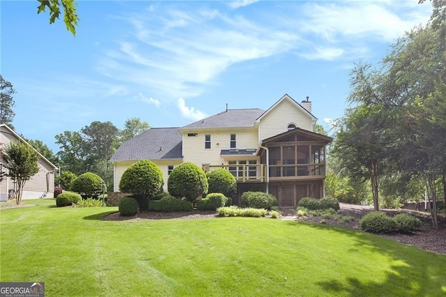 106 Waterford Pl, Acworth, GA 30101 - rear view of house featuring a sunroom, a chimney, a yard, and roof with shingles