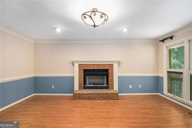 106 Waterford Pl, Acworth, GA 30101 - unfurnished living room featuring wood finished floors, ornamental molding, baseboards, a brick fireplace, and recessed lighting