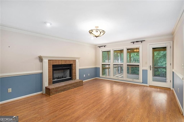 106 Waterford Pl, Acworth, GA 30101 - unfurnished living room with plenty of natural light, ornamental molding, a fireplace, wood finished floors, and baseboards