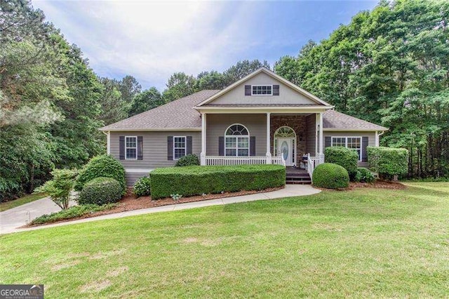 view of front of home featuring covered porch and a front yard