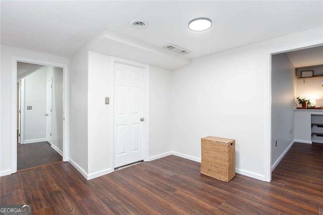 empty room with wood finished floors and baseboards
