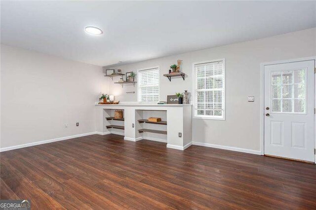 unfurnished living room with wood finished floors, baseboards, and recessed lighting