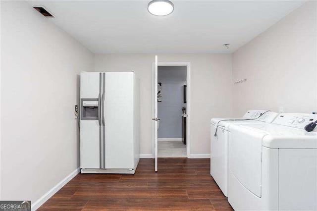 laundry room with separate washer and dryer, dark wood-type flooring, and baseboards