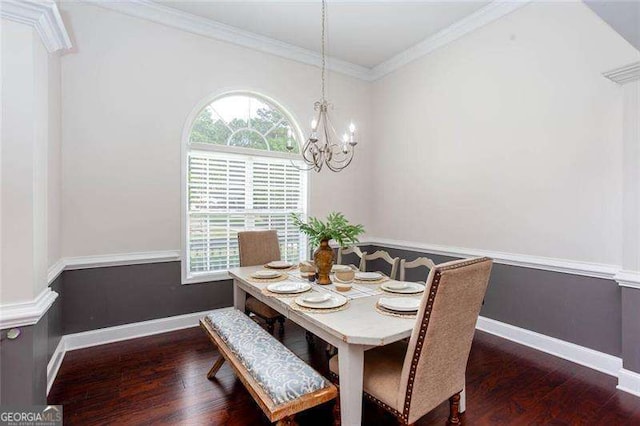 dining area with wood finished floors, a chandelier, crown molding, and baseboards