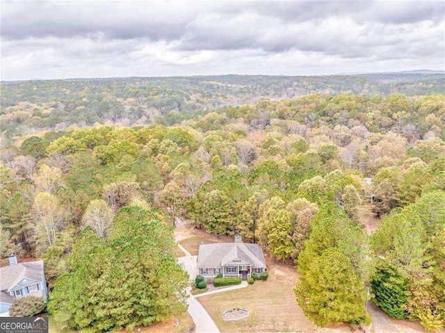view from above of property with a heavily wooded area
