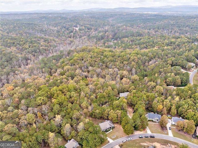 view of property location featuring a forest