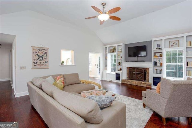 living room featuring vaulted ceiling, a ceiling fan, a fireplace, hardwood / wood-style floors, and baseboards