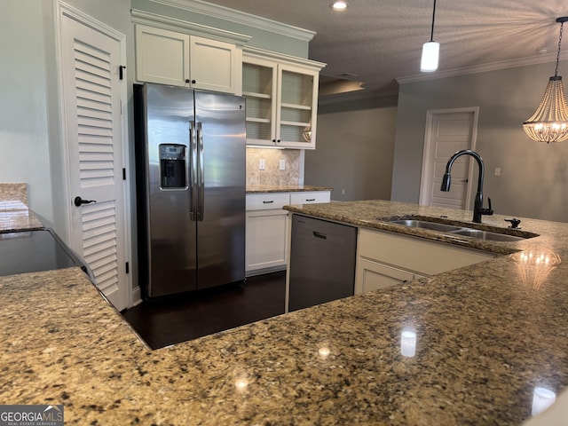 293 Laurel Landing Blvd, Kingsland, GA 31548 - kitchen featuring appliances with stainless steel finishes, a sink, crown molding, decorative backsplash, and dark stone counters