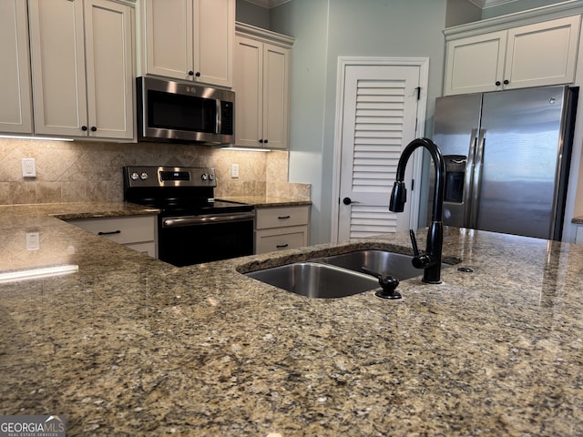 293 Laurel Landing Blvd, Kingsland, GA 31548 - kitchen featuring appliances with stainless steel finishes, a sink, crown molding, dark stone counters, and backsplash